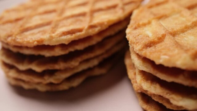 Close-up Belgium Crispy Butter Waffles pouring honey on 360 degree rotating plate
