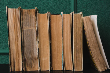 Old books on a green background. Education and knowledge concept. There is space for copy space