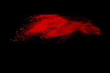 abstract powder splatted background. Freeze motion red powder explosion on black background