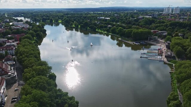 An aerial drone view of Aasee Lake in M&uuml;nster . Lake Aasee is an artificial lake located in M&uuml;nster , Germany .