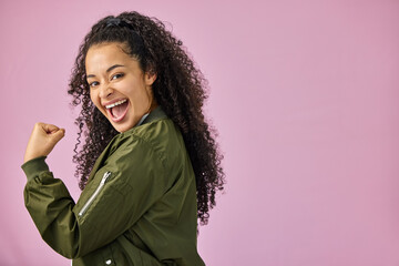 Portrait, space and winner with woman on pink background in studio for celebration of bonus. Emoji, fist and mockup with happy person cheering for achievement, motivation and promotion success