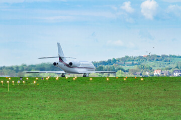 Prywatny odrzutowiec kołujący na pasie startowym na malowniczym lotnisku w Balicach | A private jet taxiing on the runway at the picturesque airport in Balice