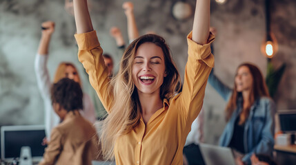 Against the backdrop of a bustling office environment, a white woman throws her arms around her teammates in celebration, her joyful smile capturing the spirit of teamwork and achi