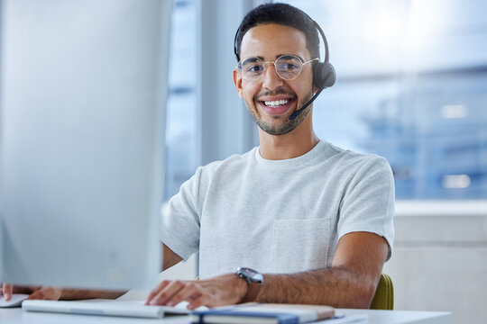Man, portrait and headset at computer or call centre for technical support, telemarketing or crm. Male person, face and smile for customer service at help desk as it advisor, consultation or contact