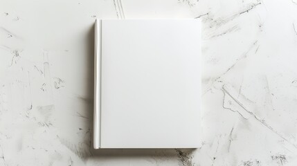 The image shows a closed blank square book on a background of white textured paper.