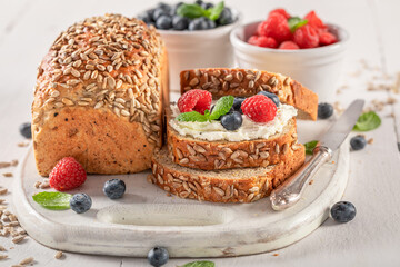 Sweet and homemade whole grain bread with cheese and berries.