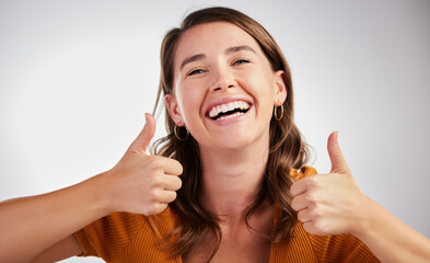 Happy woman, portrait and good job with thumbs up for winning or reaction on a gray studio...