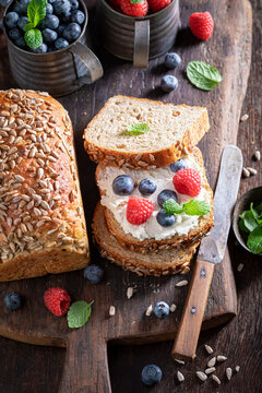 Homemade and healthy whole grain bread with cheese and berries.