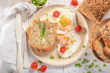 American breakfast with egg, tomato and bread.