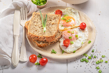 British breakfast with egg, tomato and bread.