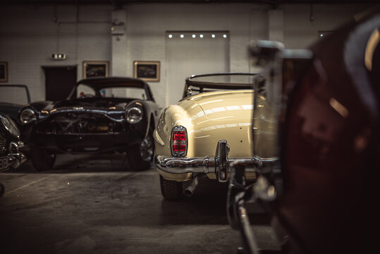 Classic cars being restored in a vintage vehicle garage workshop