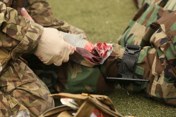Medical exercise. Medical instructorputs on a tourniquet during an exercise
