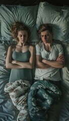 A young couple in bed, turned away from each other with arms crossed, embodying moments of tension