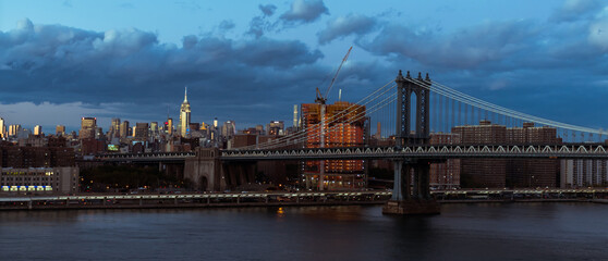Manhattan Bridge in New York City, NY. The Manhattan Bridge is a suspension bridge that crosses the East River in New York City.