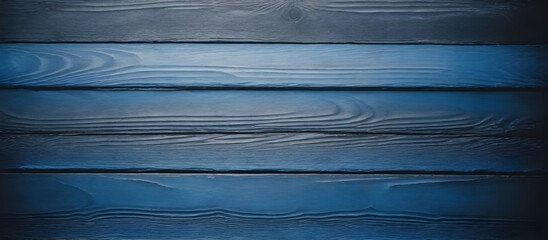 Close-up view of a dark blue wood background featuring a distinct wooden grain pattern