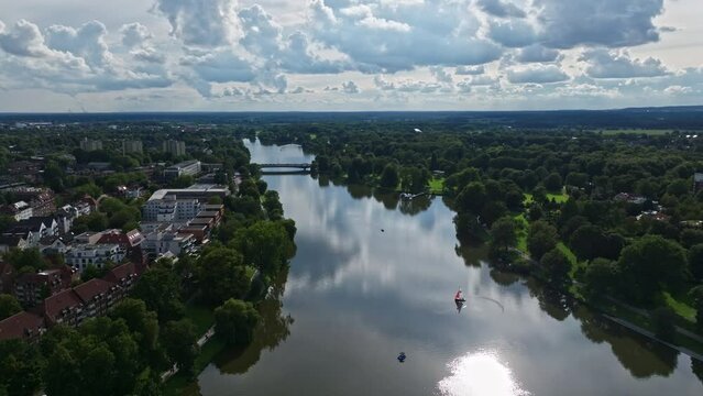 An aerial drone view of Aasee Lake in M&uuml;nster . Lake Aasee is an artificial lake located in M&uuml;nster , Germany .