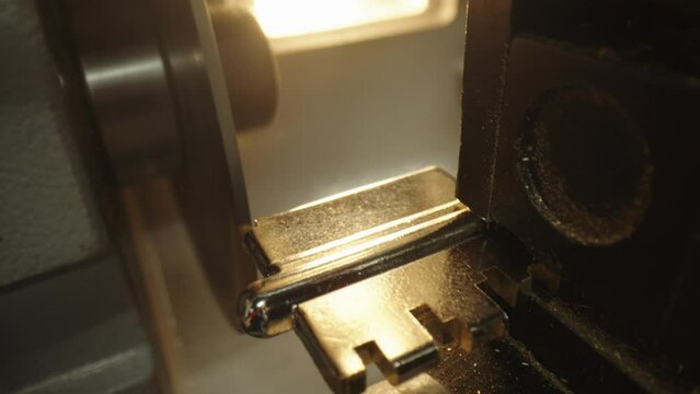 Making duplicate keys for a door lock. The process of making a duplicate key on a professional machine in a workshop.