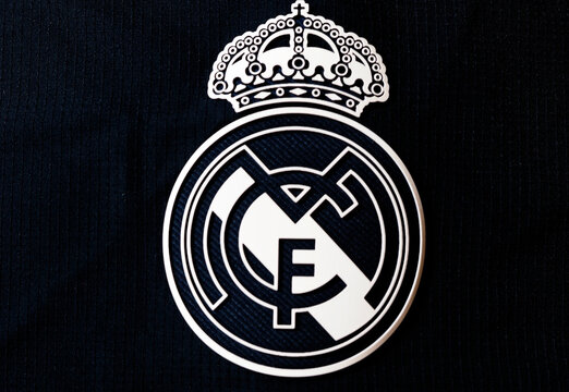 In this photo illustration,  Real Madrid CF logo seen displayed on a sportswear
