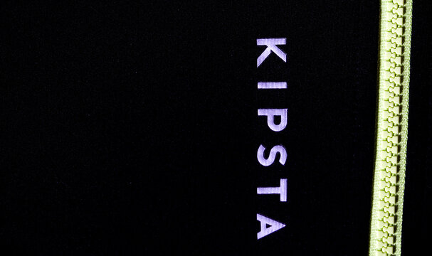In this photo illustration,  Kipsta logo seen displayed on a sportswear.