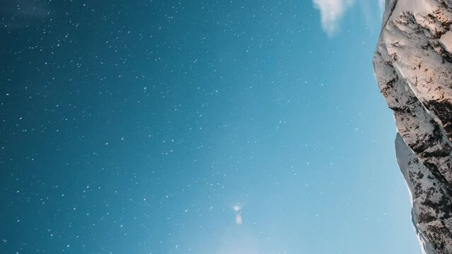 Stepantsminda, Georgia. Hyperlapse Winter Night Starry Sky With Glowing Stars And Peak Of Mount Kazbek Covered With Snow. Beautiful Night Georgian Winter Landscape. Vertical Footage.