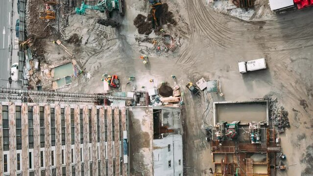 Development Multistorey Residential Building. HD Timelapse Aerial View On Construction Site. Busy Urban Traffic. Processing Of Metal Structures Building Skeleton At Construction Site. Various