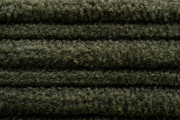 a close-up shot of a green corduroy outfit