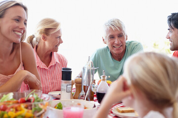 Family, food and conversation with lunch at table for relationship for relax with healthy eating...