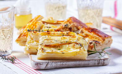 Puff pastry pie with cheese, pears, nuts and honey, served with champagne. - 790186619