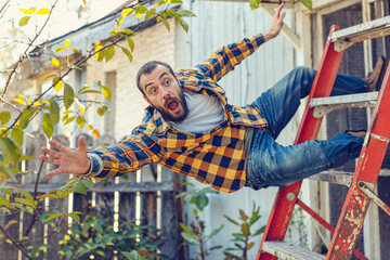 Man falling off a ladder in backyard, home accident, injury, fall, DIY repair