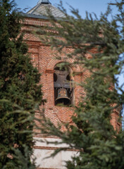 Church tower with bell in the village