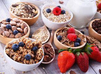 Bowls with different sorts of breakfast cereal products - 790193447