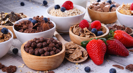 Bowls with different sorts of breakfast cereal products - 790193653