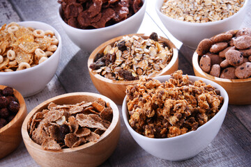 Bowls with different sorts of breakfast cereal products - 790193679