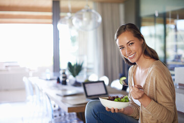 Woman, portrait and eating a salad in home, green vegetables and vegan diet for nutrition. Female...