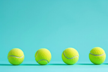 Row of tennis balls on blue background with copy space for text - Powered by Adobe