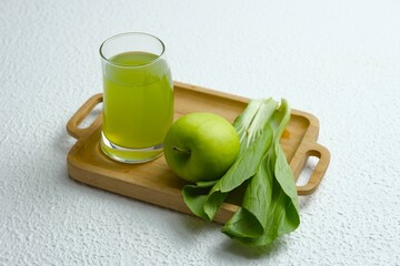 Isolated green juice on white background. Healthy drink made from pakchoy vegetables and green...