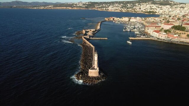 Aerial top view by drone of lighthouse with old Venetian harbor in Chania city on Crete island, Greece.