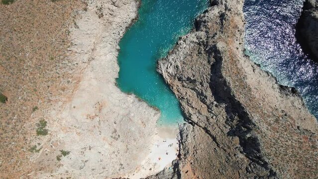 Aerial top view by drone of beach of Seitan Limania in bay with turquoise water and an unusual shape in Akrotiri, Crete.