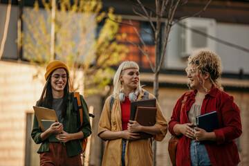 Group of young women laughing and chatting on their way to class