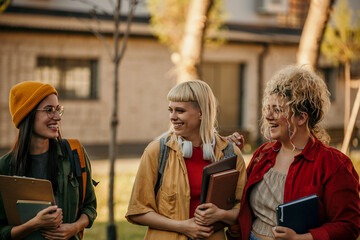 Group of young women laughing and chatting on their way to class