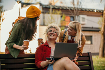 Confident smiling millennial female student with blond curly hair wearing casual clothes and...