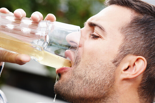 Person, drinking and healthy probiotic juice for natural, organic and refreshing liquid for energy. Vegan, man and glass of kombucha beverage for health, wellness and nutrition for digestion