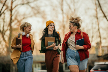 Young women walk past the college yard