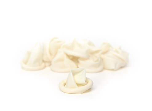 Finger cots with defocused pile. Rubber latex or nitril. Used for medical administration, skin protection and spa services. Known as finger frock or finger stall. Selective focus. White background.