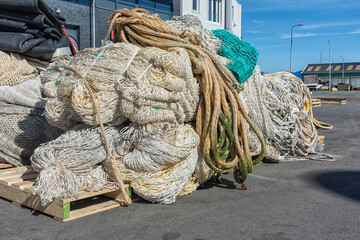 various types of professional fishing nets, including back nets are located outside on the harbor quay