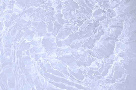 wavy white water with circles and ripples surface. white water texture with sunlight reflection for background 
