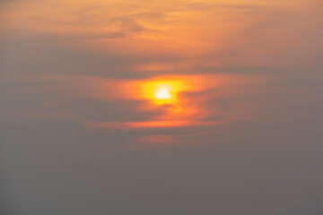 Evening sky time with sun and orange clouds in sunset sky background.Heat wave hot sun, climate change and global warming concept.