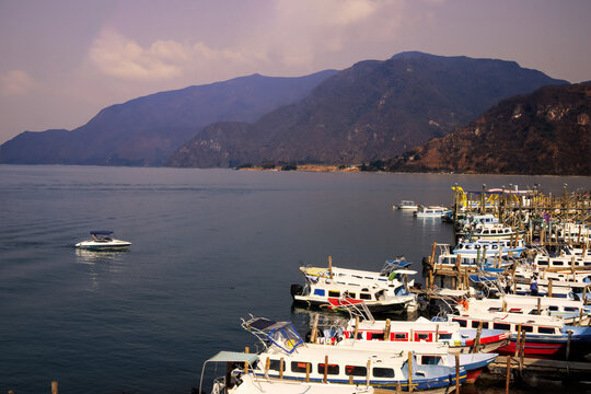Lake jetty surrounded by misty mountains