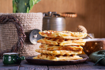 Belgian waffles served with honey, cream and sai on a wooden background. Rustic style. - 790233644