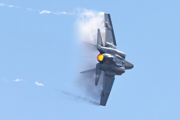 Very  close view of a F-35C Lightning II  in a high G turn, in a condensation cloud, with trails at...